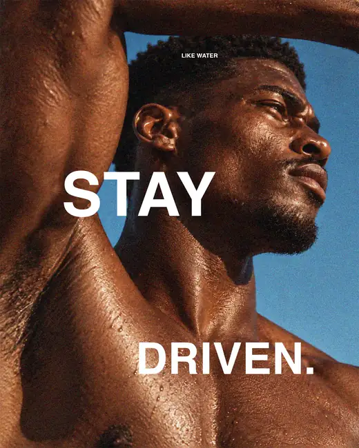 Runner reaching upward with a can of Like Water — “Stay driven”