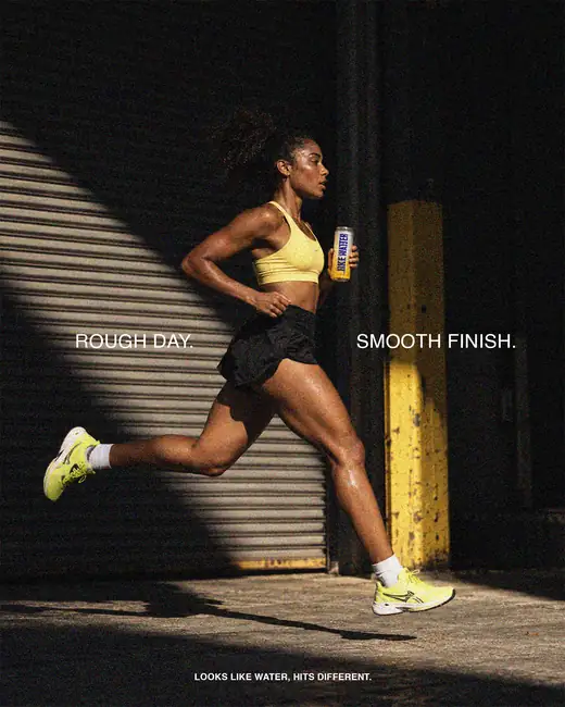 Sprinter running past a shuttered wall at night with a can of Like Water — “Rough day. Smooth finish.”